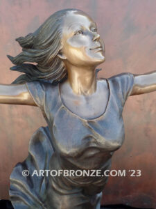 Wind Swept bronze statue joyous woman gracefully balancing on one foot