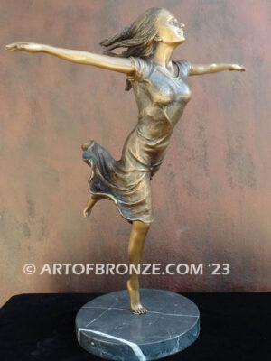 Wind Swept bronze statue joyous woman gracefully balancing on one foot