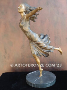 Wind Swept bronze statue joyous woman gracefully balancing on one foot