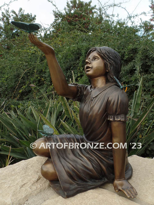 Wings of Joy bronze sculpture of sitting girl in dress with bronzes butterflies