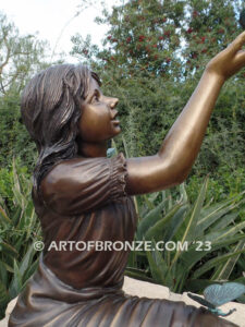 Wings of Joy bronze sculpture of sitting girl in dress with bronzes butterflies