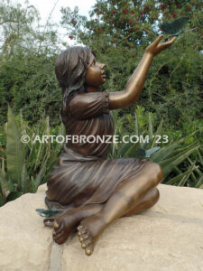 Wings of Joy bronze sculpture of sitting girl in dress with bronzes butterflies