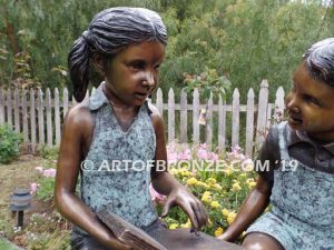 Bronze Statue of Girl Reading Book to Boy