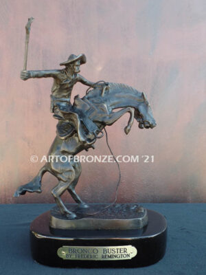 The Bronco Buster bronze sculpture after Frederic Remington featuring cowboy on horse