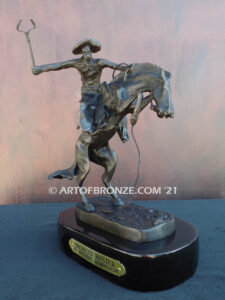 The Bronco Buster bronze sculpture after Frederic Remington featuring cowboy on horse