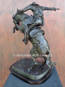 The Large Bronco Buster bronze statue after Frederic Remington featuring cowboy on horse