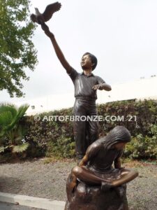 High Hopes bronze sculpture of four children playing on bronze rock for park or school playground