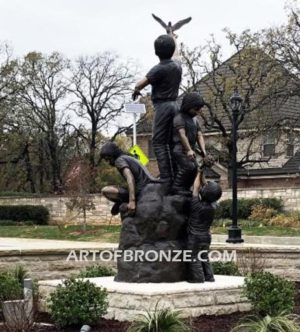 High Hopes bronze sculpture of kids playing on bronze rock for park or school playground