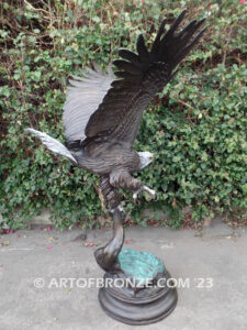 Majesty monumental bronze sculpture of eagle landing on branch