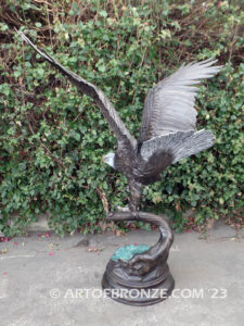 Majesty monumental bronze sculpture of eagle landing on branch