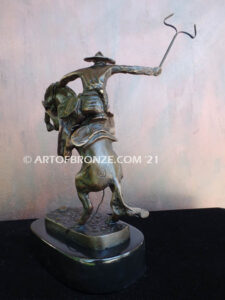 The Bronco Buster bronze sculpture after Frederic Remington featuring cowboy on horse