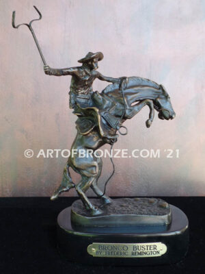 The Bronco Buster bronze sculpture after Frederic Remington featuring cowboy on horse