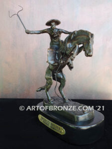 The Bronco Buster bronze sculpture after Frederic Remington featuring cowboy on horse