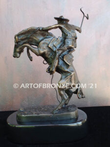 The Bronco Buster bronze sculpture after Frederic Remington featuring cowboy on horse