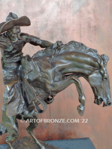 The Bronco Buster bronze sculpture after Frederic Remington featuring cowboy on horse