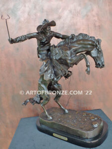 The Bronco Buster bronze sculpture after Frederic Remington featuring cowboy on horse