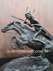 The Cheyenne bronze sculpture after Frederic Remington featuring warrior on galloping horse