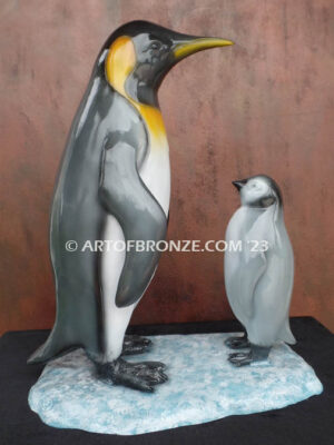 Ice Lessons bronze statue of mother king penguin and chick standing together