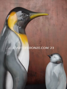 Ice Lessons bronze statue of mother king penguin and chick standing together