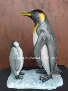 Ice Lessons bronze statue of mother king penguin and chick standing together