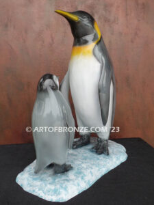 Ice Lessons bronze statue of mother king penguin and chick standing together
