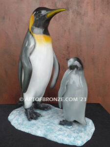 Ice Lessons bronze statue of mother king penguin and chick standing together