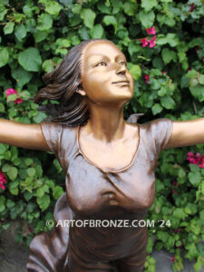 Wind Swept bronze sculpture joyous woman gracefully balancing on one foot