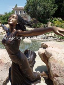 Wind Swept bronze statue joyous woman gracefully balancing on one foot