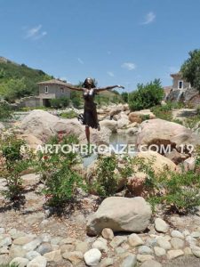 Wind Swept bronze statue joyous woman gracefully balancing on one foot
