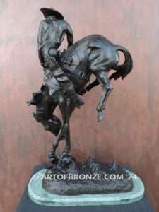 Outlaw bronze sculpture cowboy on bucking horse after Frederic Remington