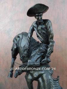 Outlaw bronze sculpture cowboy on bucking horse after Frederic Remington