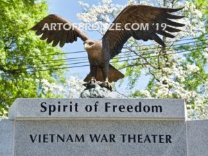 Vietnam War Memorial outdoor monumental statue of an eagle landing atop granite pillar