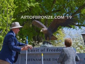 Vietnam War Memorial outdoor monumental statue of an eagle landing atop granite pillar