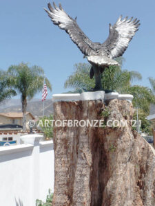 Thunder and Lightning monumental bronze eagle statue anchored a top a massive tree