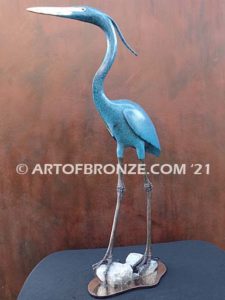 Heron in Everglades sculpture heron standing on rocks by British artist Brian Arthur