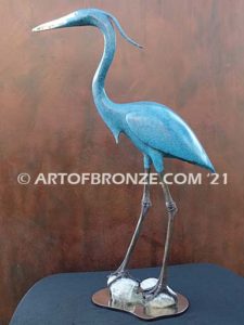 Heron in Everglades sculpture heron standing on rocks by British artist Brian Arthur