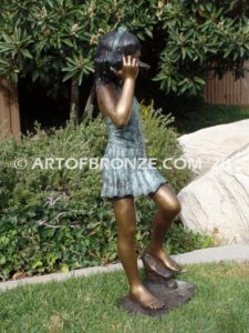 Captivating bronze fountain sculpture of girl standing with seashell in hand