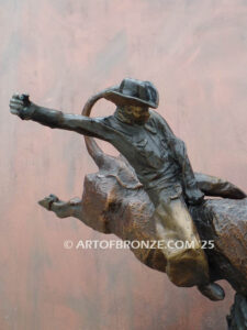 All on the Line bronze sculpture of rider atop bull attached to a marble base