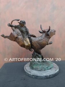 All on the Line sculpture of bull rider riding jumping bull attached to a marble base