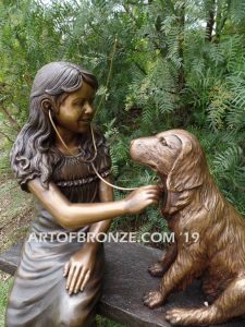 Checkup bronze sculpture of seated veterinarian girl and dog on bench with girl holding stethoscope