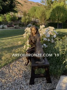 Checkup bronze sculpture of seated veterinarian girl and dog on bench with girl holding stethoscope