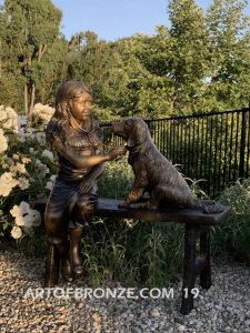 Checkup bronze sculpture of seated veterinarian girl and dog on bench with girl holding stethoscope