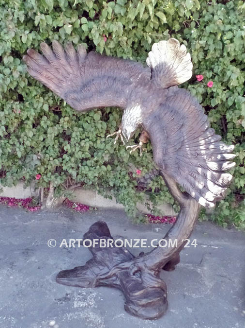 Down Draft bronze sculpture of striking bald eagle attached to bronze branch