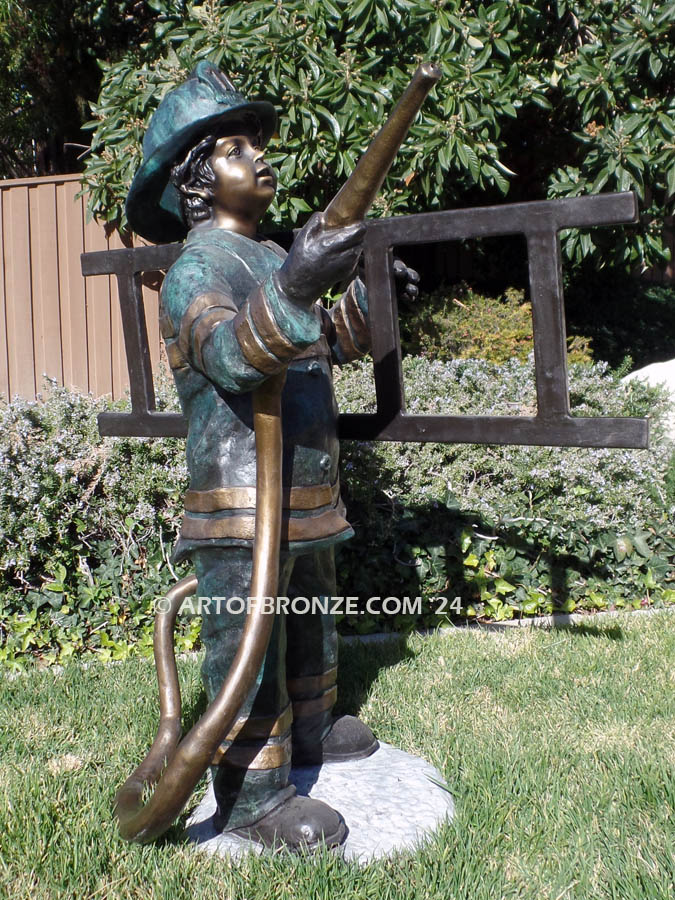 Junior Fireman bronze sculpture of firefighter boy wearing helmet and turnout coat
