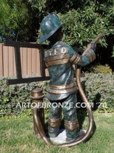 Junior Fireman bronze sculpture of firefighter boy wearing helmet and turnout coat