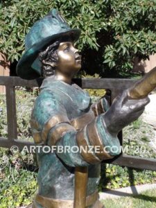 Junior Fireman bronze sculpture of firefighter boy wearing helmet and turnout coat