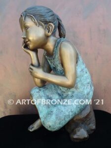Cutie Pie bronze sculpture of girl sitting down and daydreaming