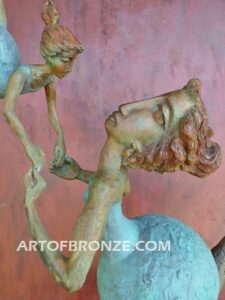 Maternidad bronze gallery sculpture of mother swinging daughter on steel pedestal