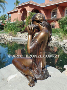 Illusion bronze sculpture of exotic nude woman listening to shell for private gallery or public display