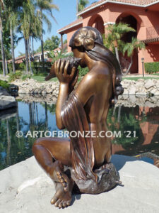 Illusion bronze sculpture of exotic nude woman listening to shell for private gallery or public display